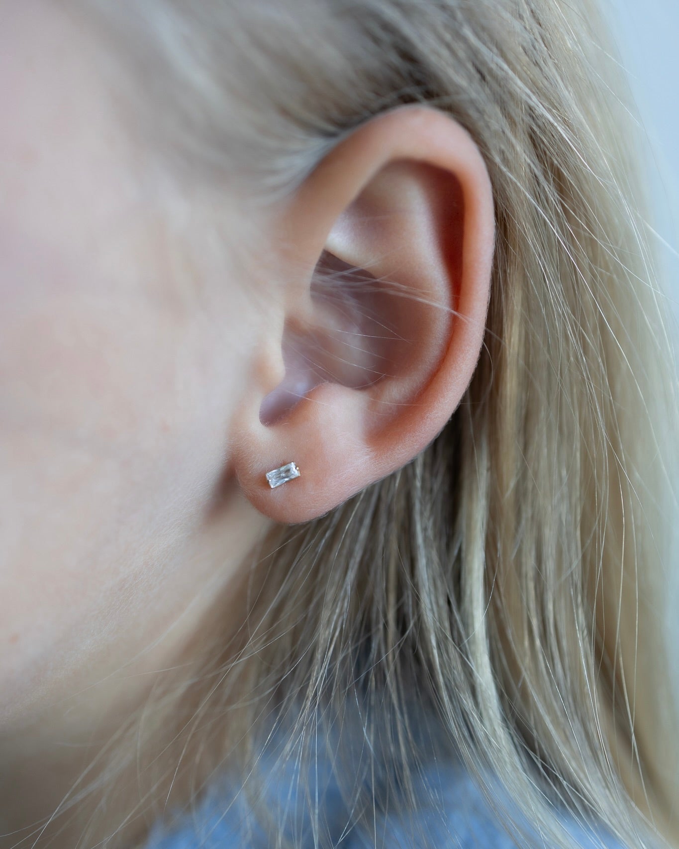 Baguette clear zircon stud earring worn on a child, titanium kids jewelry with flat back for everyday wear