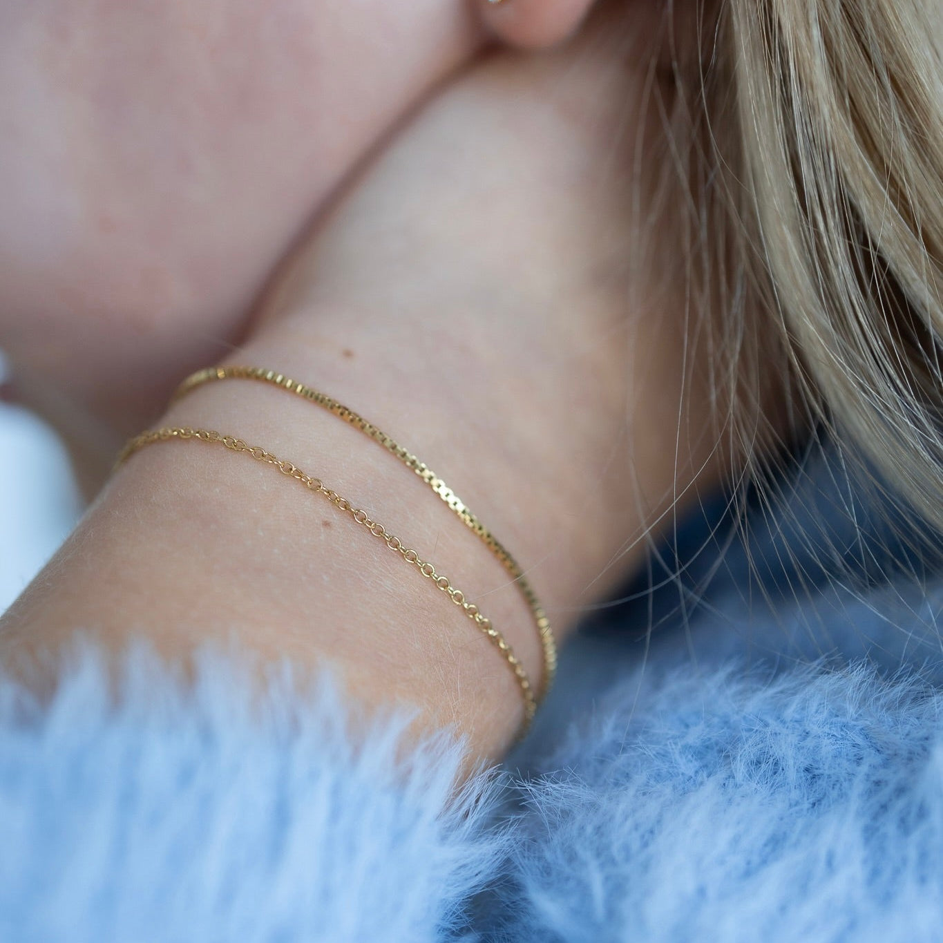 Gold stainless steel chain necklace layered on a child, lightweight kids jewelry designed for everyday wear